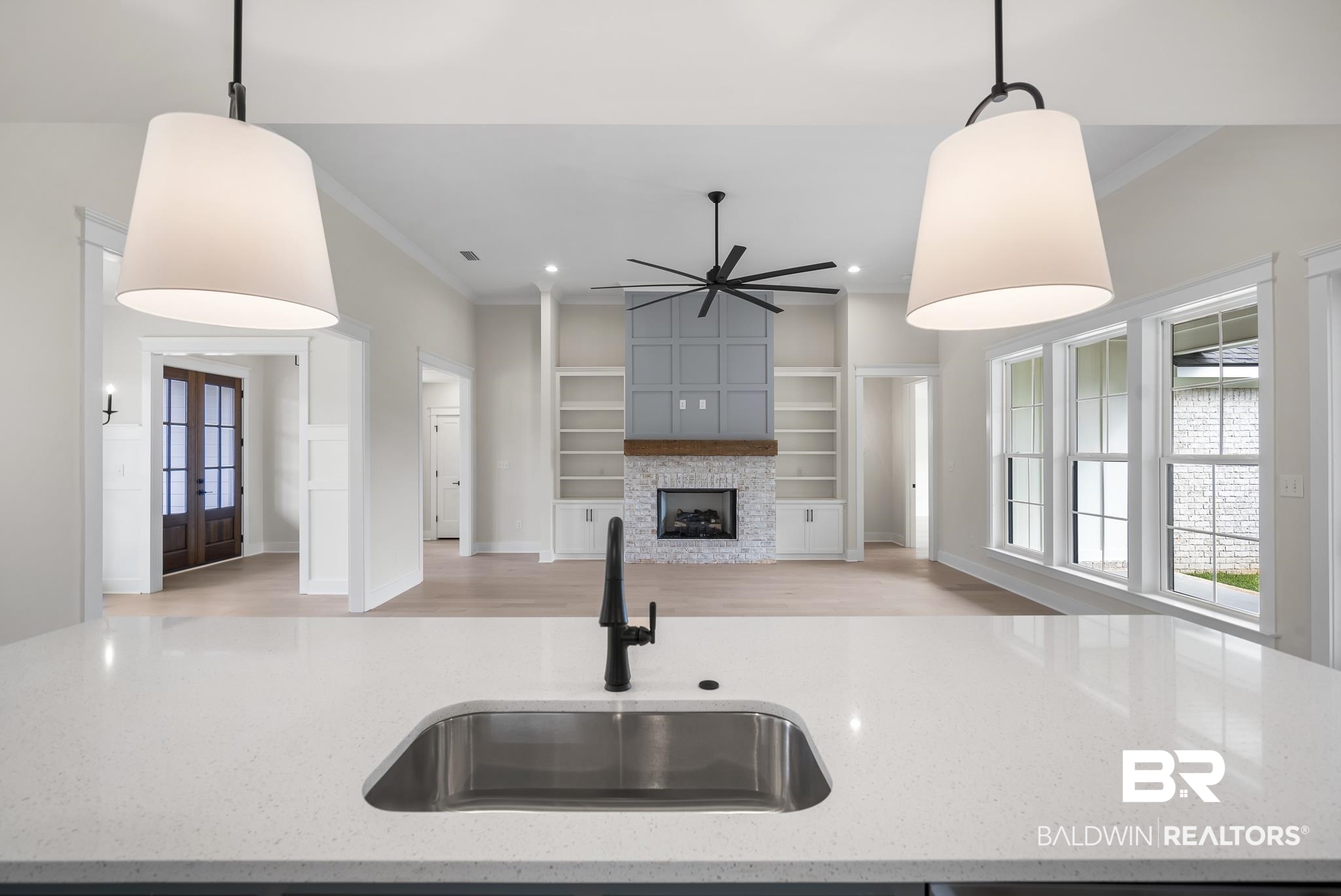 21826 Veranda Boulevard Fairhope, AL 36532 - Photo 12 of 42 Kitchen with french doors, crown molding, decorative light fixtures, ceiling fan, and light wood-style floors