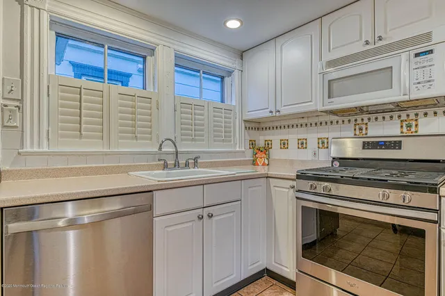 a kitchen with stainless steel appliances granite countertop a stove and a sink