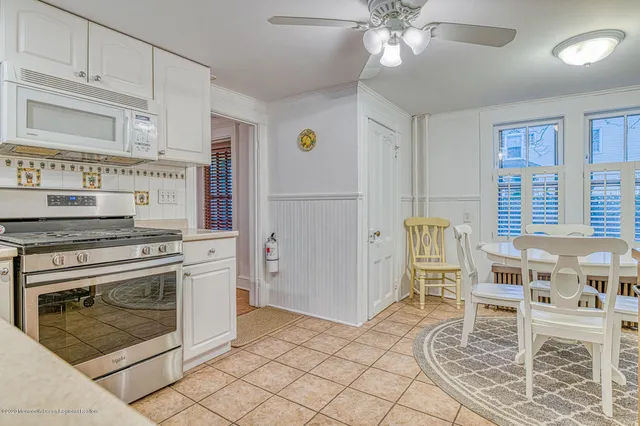 a kitchen with cabinets and chairs