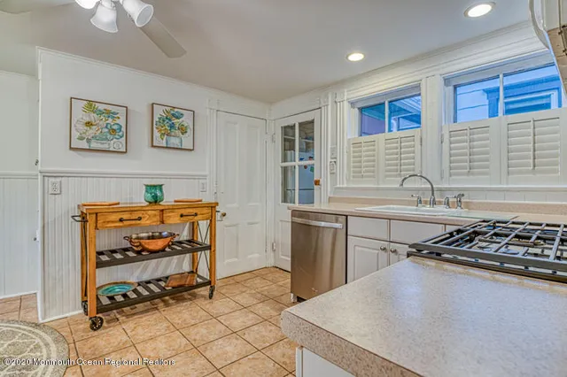 a kitchen with a cabinets a sink and a stove top oven