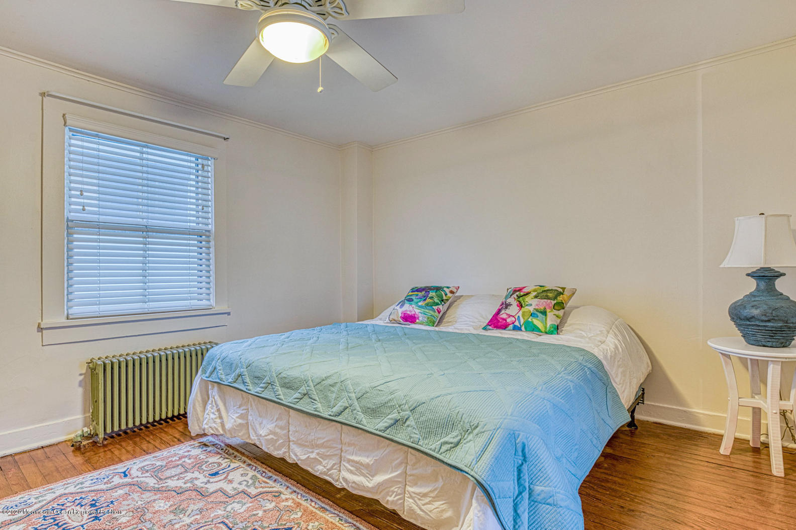 124 Main Avenue Ocean Grove, NJ 07756 - Photo 20 of 22 a bedroom with a bed and a chandelier