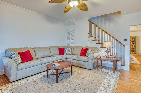 a living room with furniture and wooden floor