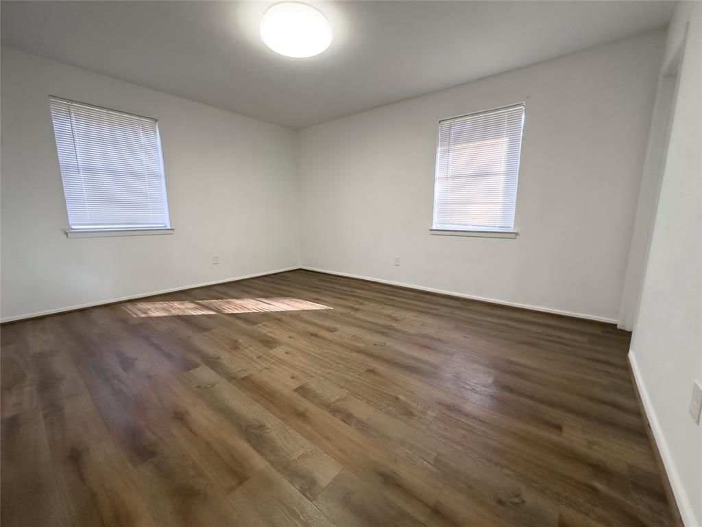 1938 Spring Drive Keller, TX 76262 - Photo 12 of 16 an empty room with wooden floor and windows