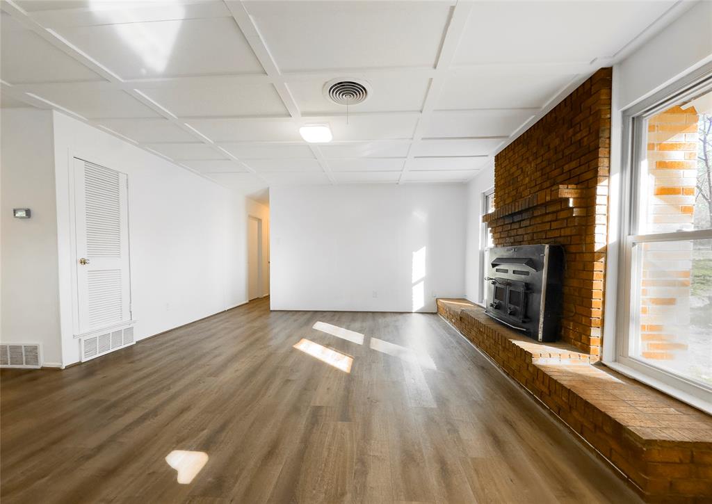1938 Spring Drive Keller, TX 76262 - Photo 2 of 16 a view of an empty room with a fireplace and a window
