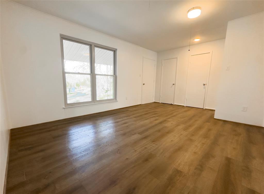 1938 Spring Drive Keller, TX 76262 - Photo 7 of 16 an empty room with wooden floor and windows