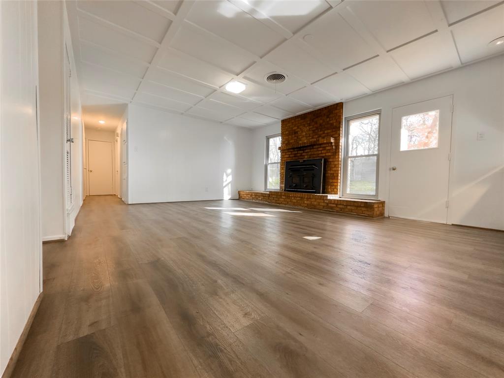 1938 Spring Drive Keller, TX 76262 - Photo 10 of 16 an empty room with wooden floor fireplace and windows