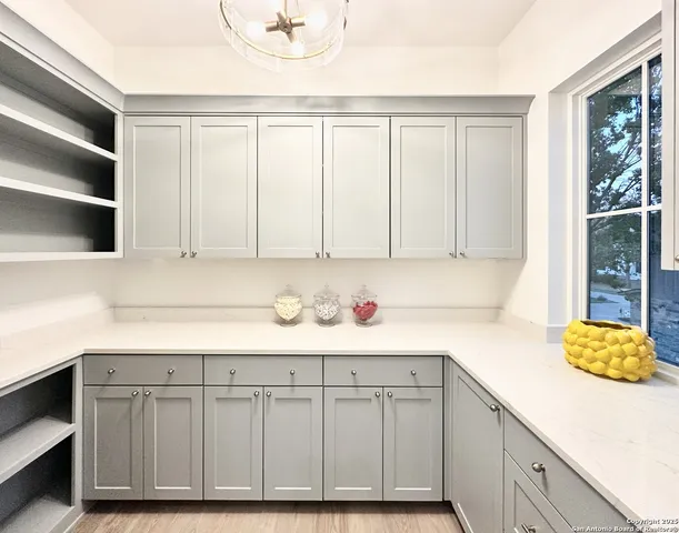 a kitchen with a white cabinets and a sink