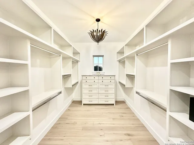 a view of walk in closet and window