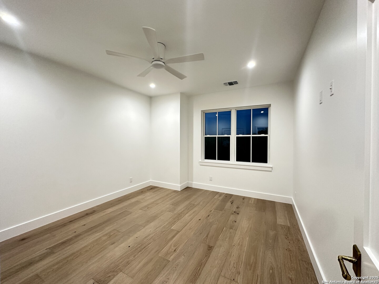 508 Lake Street Kingsland, TX 78639 - Photo 21 of 30 an empty room with wooden floor and windows