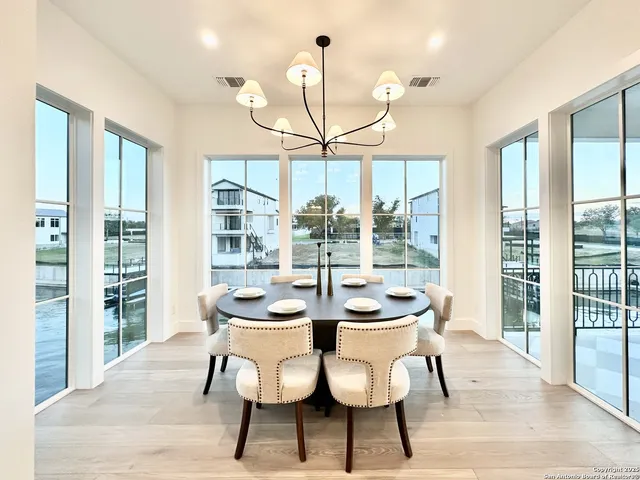 a view of a dining room with furniture wooden floor and chandelier