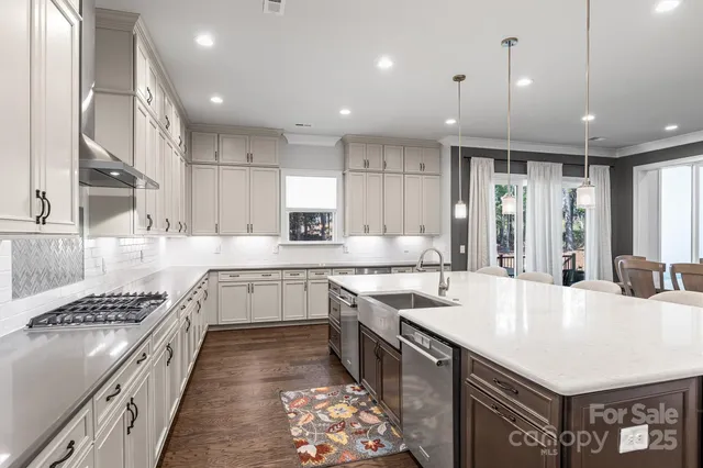 a large white kitchen with a large window
