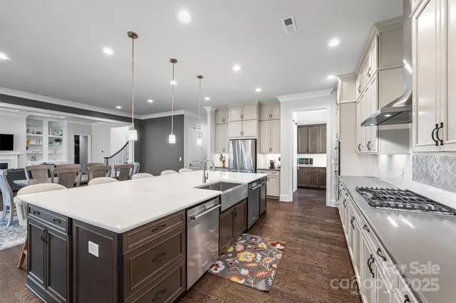 a large kitchen with kitchen island a sink stove and refrigerator