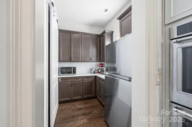 a kitchen with stainless steel appliances granite countertop a refrigerator and a sink