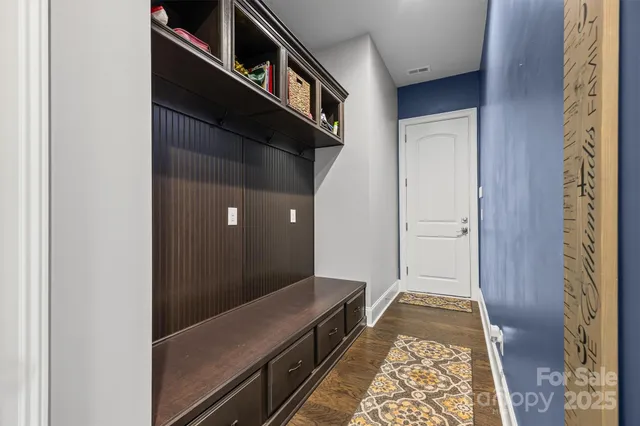 a view of hallway with wooden floor