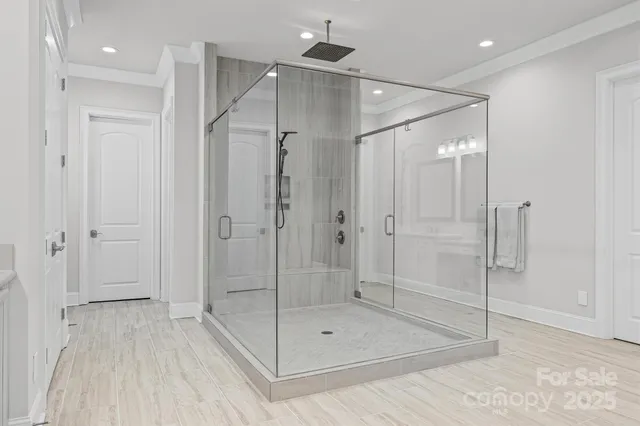 a bathroom with a shower and a glass door