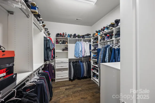 a view of walk in closet with clothes
