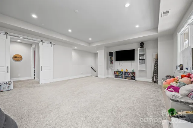 a view of empty room with a flat screen tv