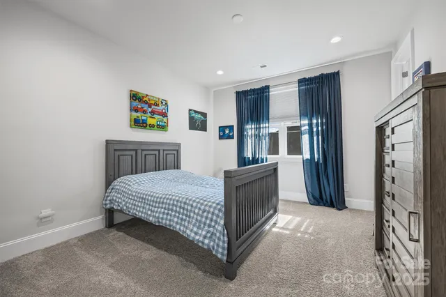 a room with a bed and a refrigerator