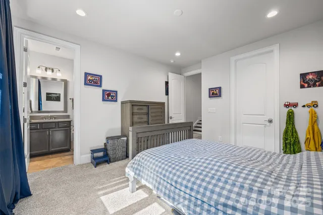 a bedroom with a bed and a television