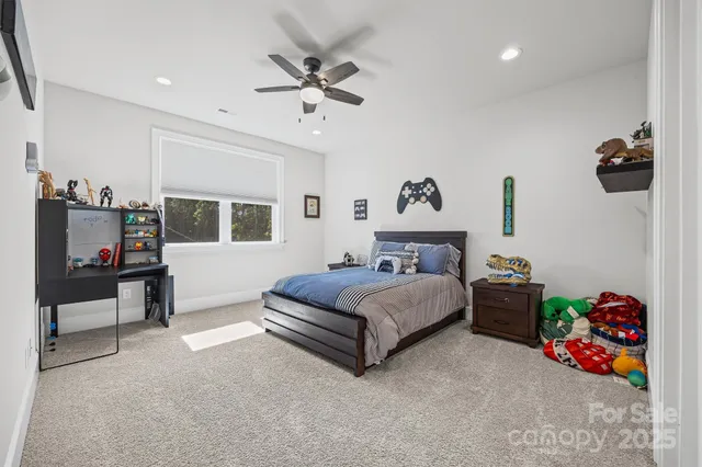 a spacious bedroom with a bed and a chandelier