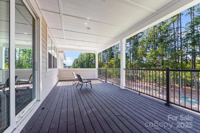 a view of a deck with furniture and yard