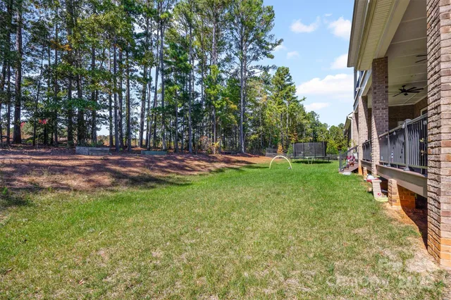 a view of a house with a yard and sitting area