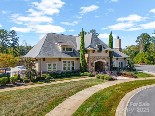 an aerial view of a house with garden space and street view