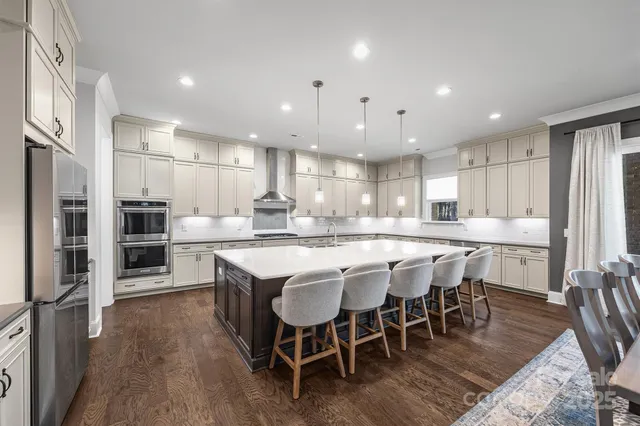 a large kitchen with cabinets table and chairs