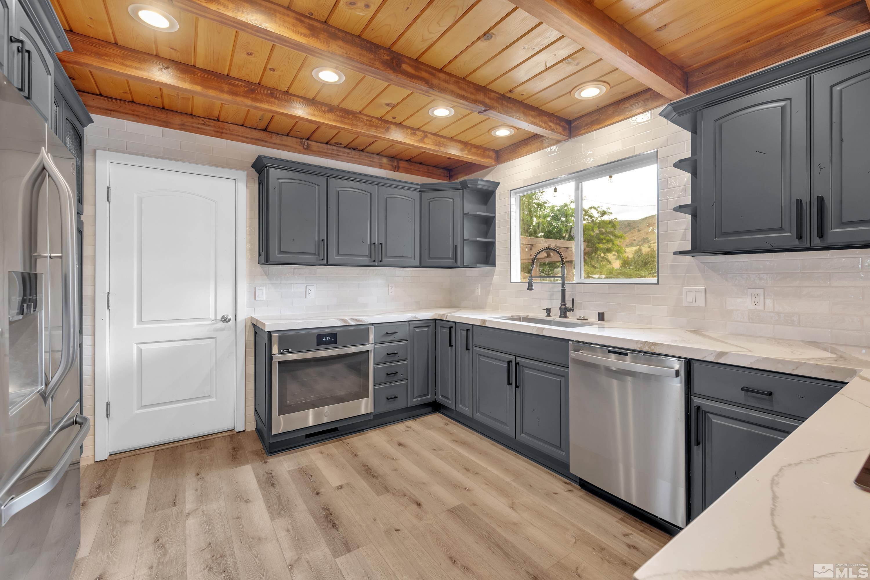 13750 Rancheros Drive Reno, NV 89521 - Photo 13 of 39 a kitchen with a sink window and cabinets
