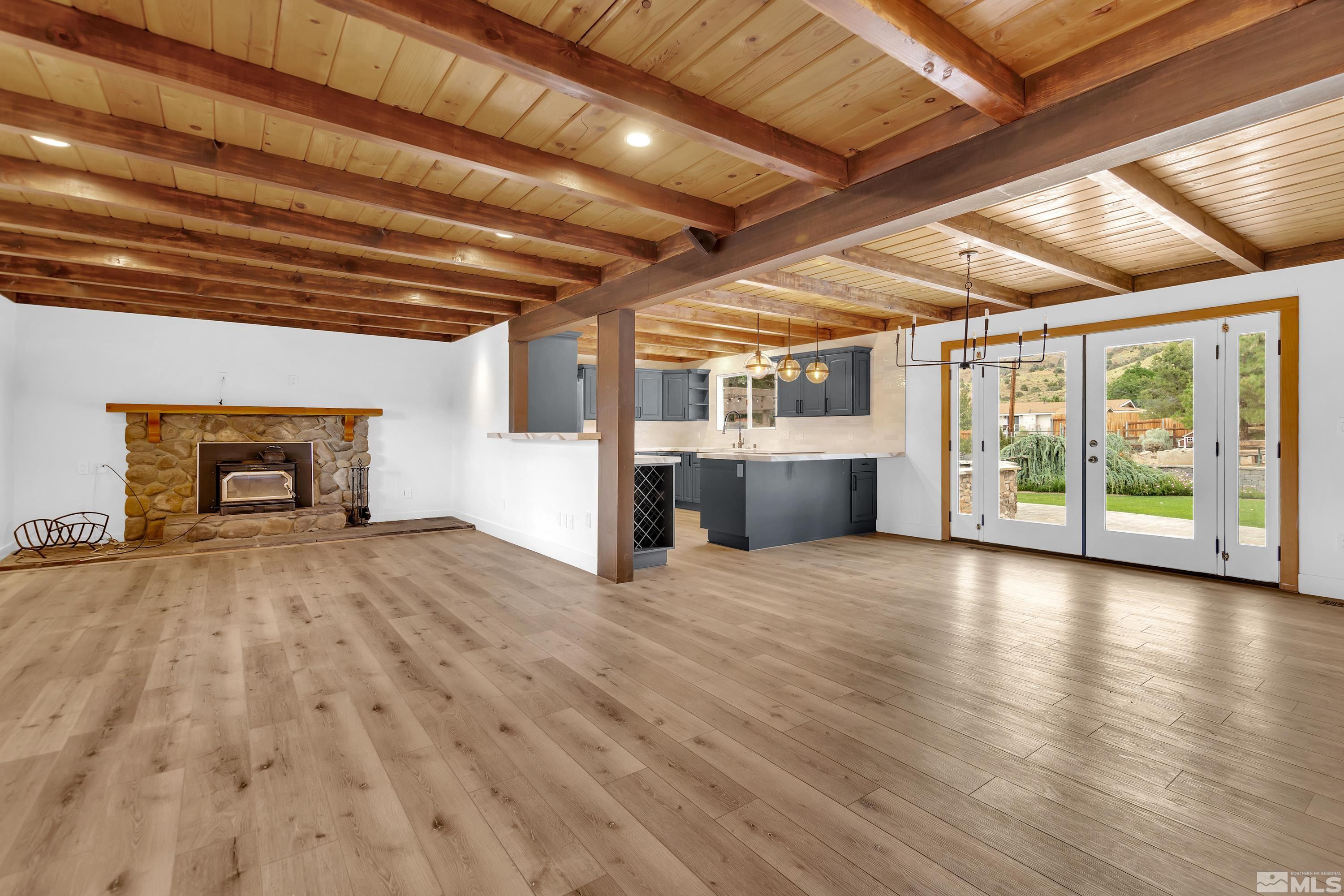 13750 Rancheros Drive Reno, NV 89521 - Photo 4 of 39 a view of empty room with wooden floor and fireplace