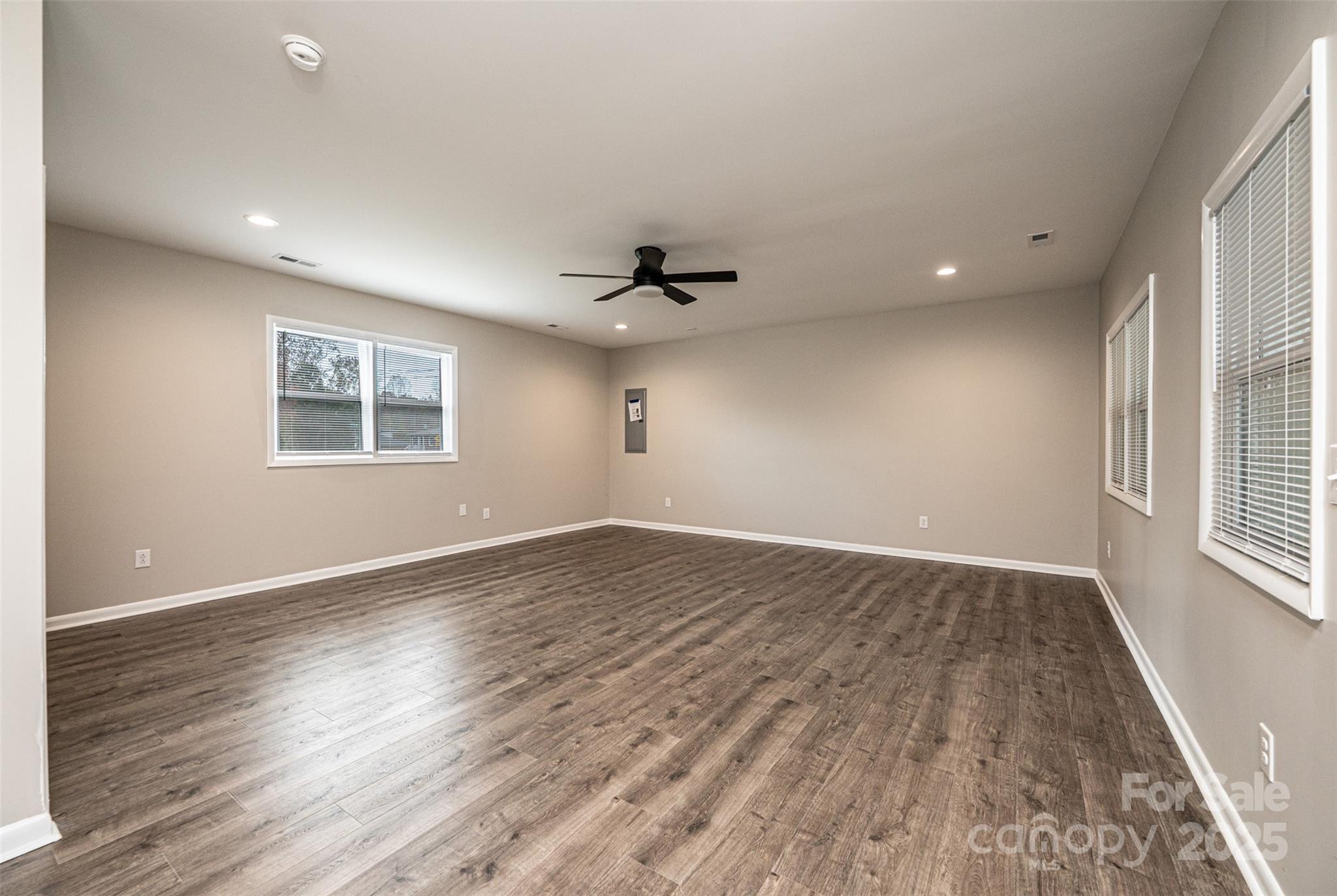 908 13th Street Northwest Conover, NC 28613 - Photo 14 of 25 an empty room with wooden floor and windows