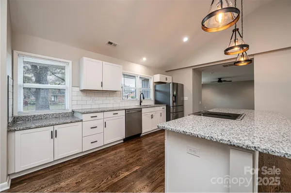 a kitchen with sink and refrigerator