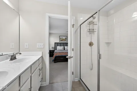 a en suite bathroom with a sink a mirror and a shower