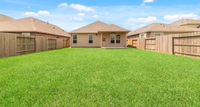 a view of a big house with a big yard and large trees