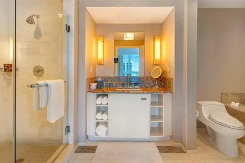 a bathroom with a granite countertop sink and a mirror