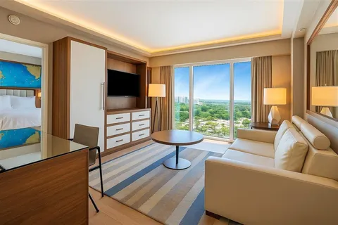 a bedroom with a bed and a flat tv screen on dresser