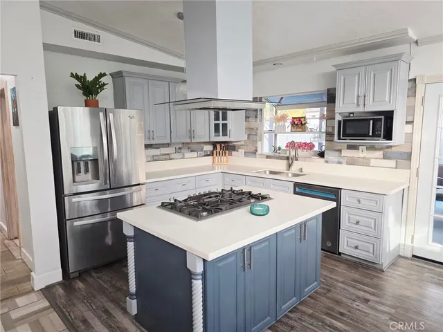 a kitchen with a sink stove and refrigerator