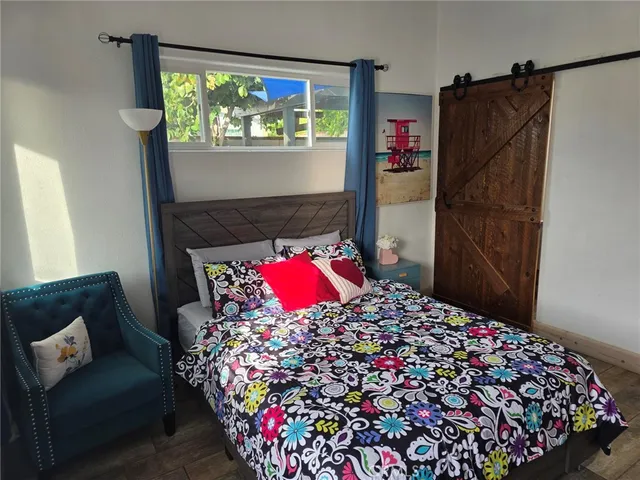 a view of a bedroom with furniture and a potted plant