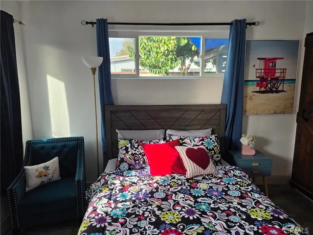 a bedroom with a bed and a window