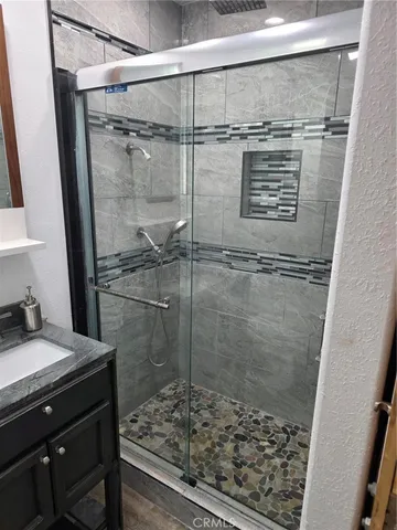 a bathroom with a shower toilet and sink