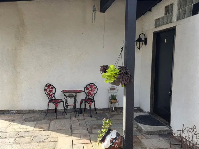 a dining room with furniture and a potted plant
