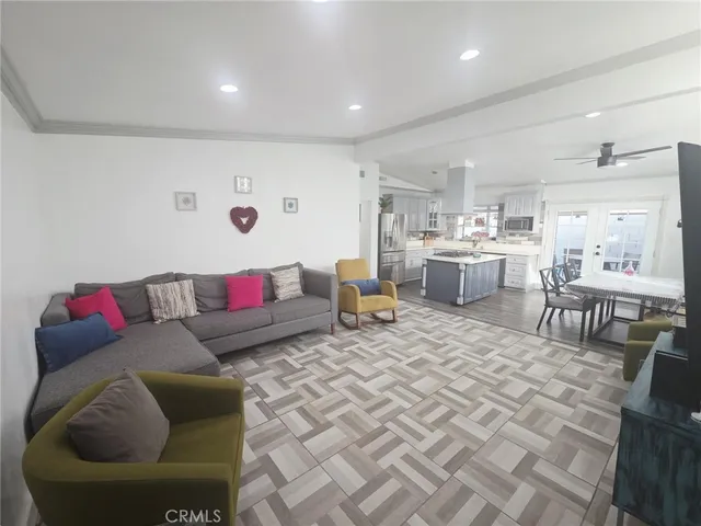 a living room with furniture and view of kitchen