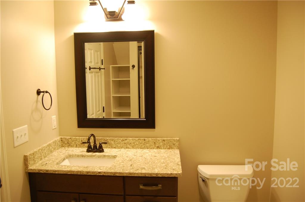 3101 Colony Road Charlotte, NC 28211 - Photo 19 of 26 a bathroom with a granite countertop sink and a mirror