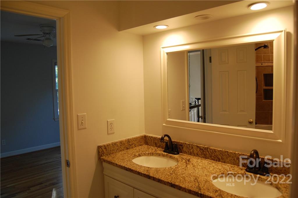 3101 Colony Road Charlotte, NC 28211 - Photo 23 of 26 a bathroom with a granite countertop sink and a mirror