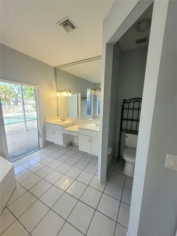 a bathroom with a sink a mirror and a bathtub