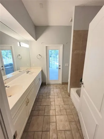 a bathroom with a sink a mirror and a shower