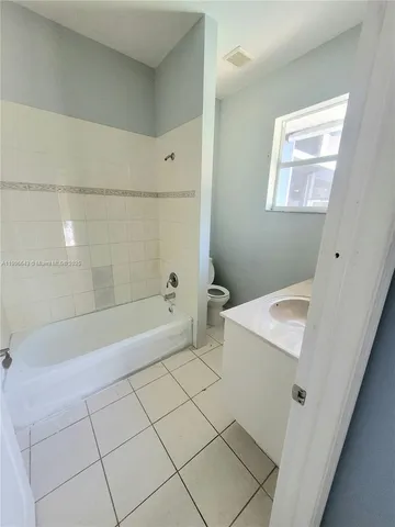 a bathroom with a sink a toilet and bathtub