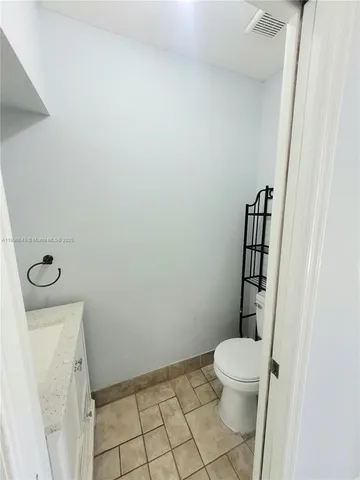 a white toilet sitting next to a bathroom sink