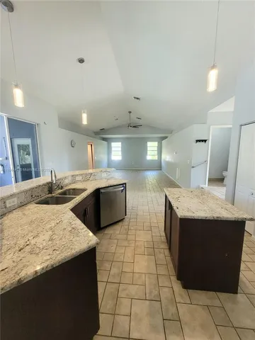 a kitchen with stainless steel appliances granite countertop a sink and a stove