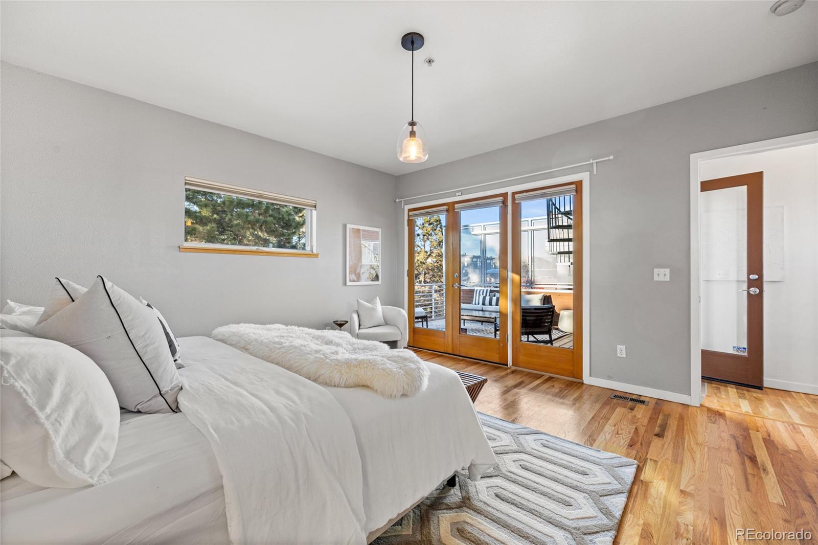 1675 Boulder Street Denver, CO 80211 - Photo 21 of 39 a bedroom with bed and a large window